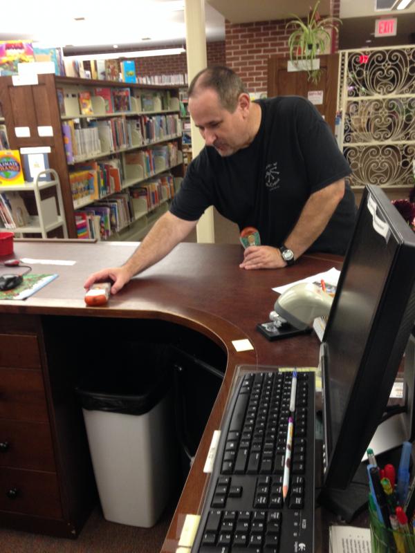 A member of S.P.I.R.I.T.S. places recording devices in the children's department. COURTESY ELIZABETH SHERRY